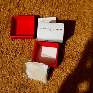 Gold tune ivory ring set size 8. It has 3 rings with it.